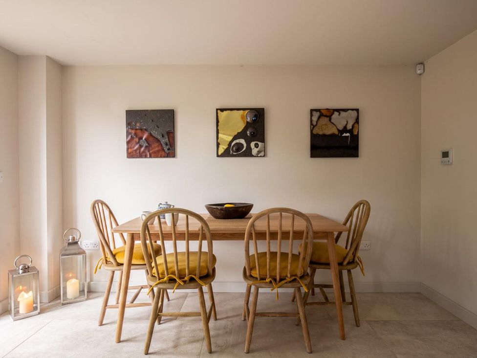 A dining room with a wooden table and chairs at The Old Barn in Manchester