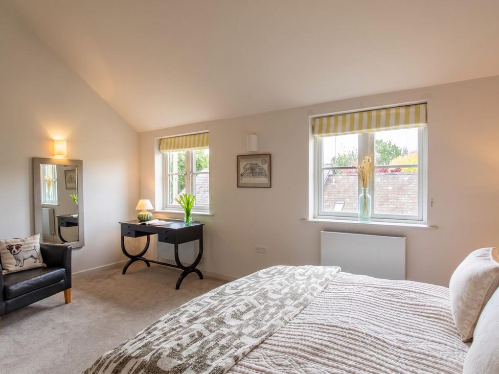 A bedroom with a bed and desk at The Old Barn in Manchester