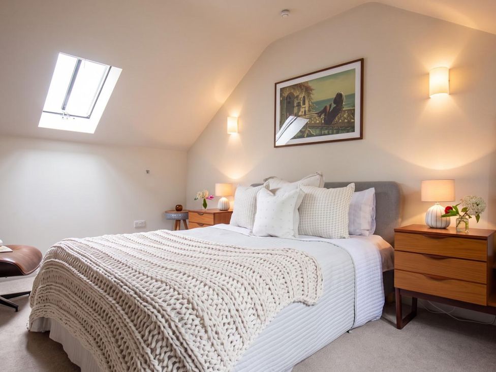 A bedroom with a bed and nightstands at The Old Barn in Manchester