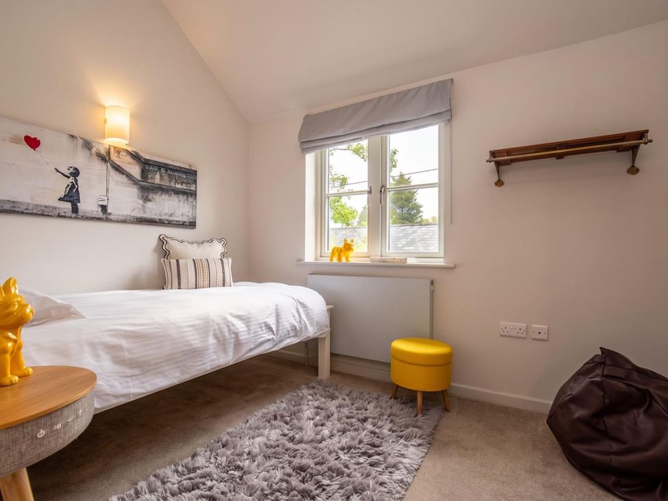 A bedroom with a bed and wall art at The Old Barn in Manchester