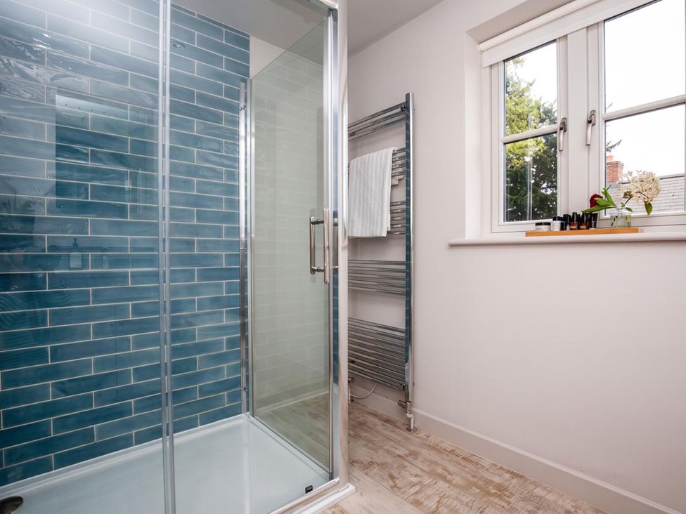 A bathroom with a shower and window at The Old Barn in Manchester
