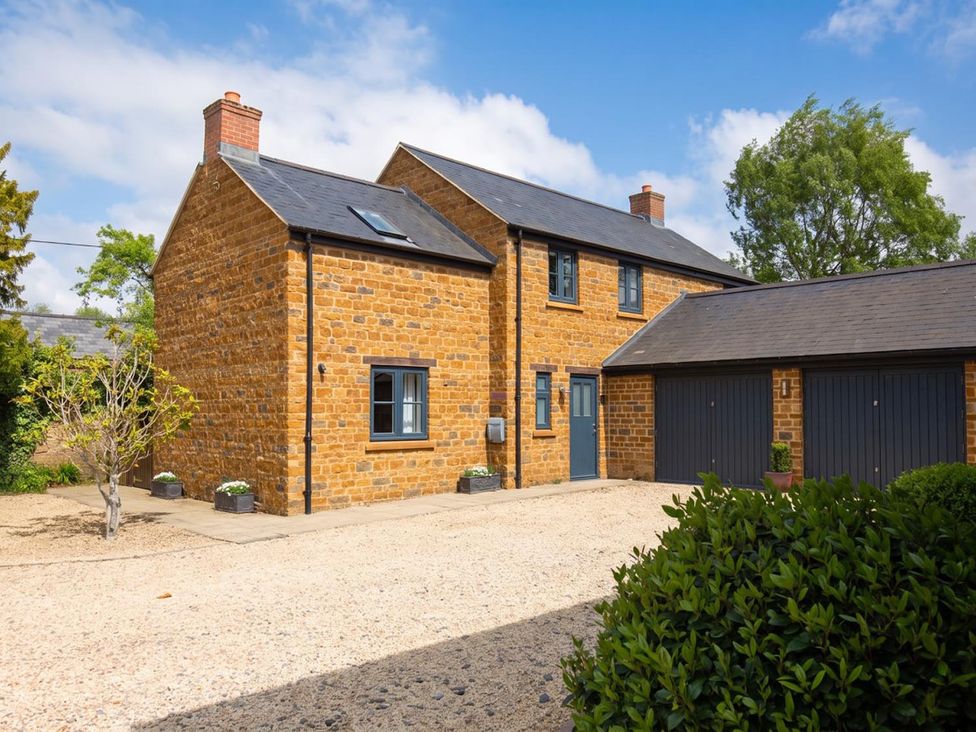 A house with a garage and plants at 