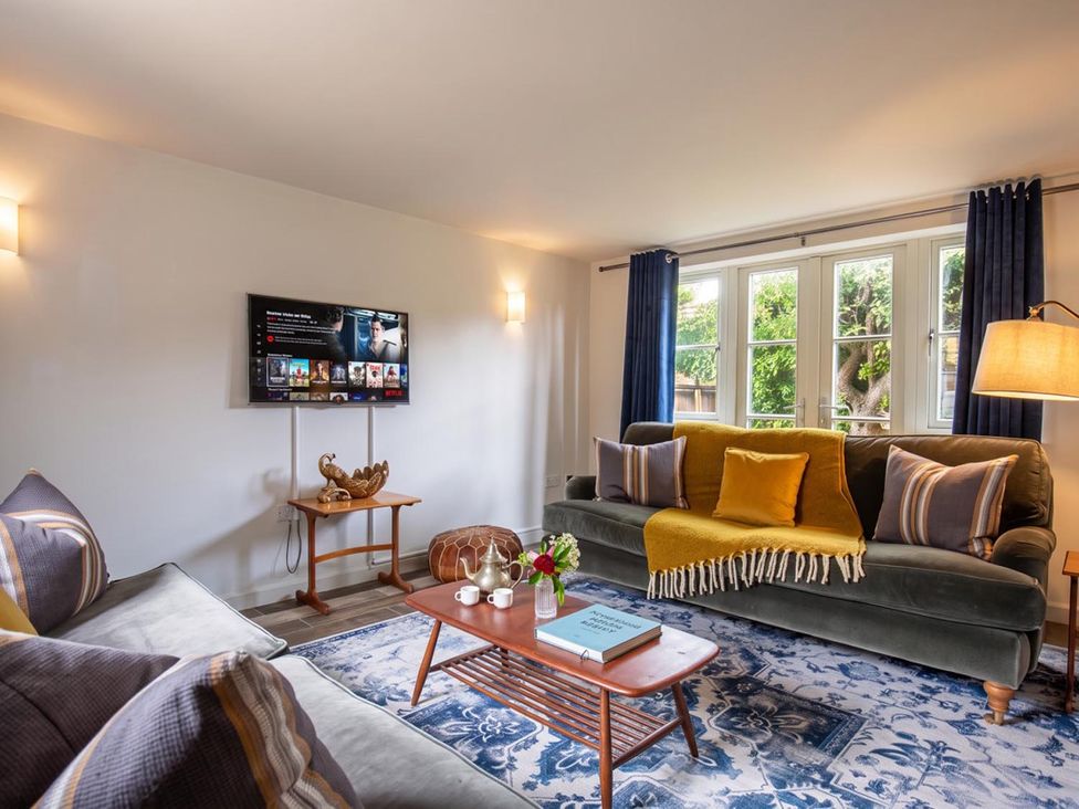 A living room with a sofa and a television at the property in location