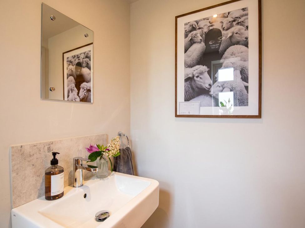A bathroom with a sink and a mirror at The Old Barn in Manchester