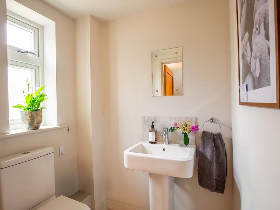 A bathroom with a sink, toilet, and plant at The Old Barn in Manchester