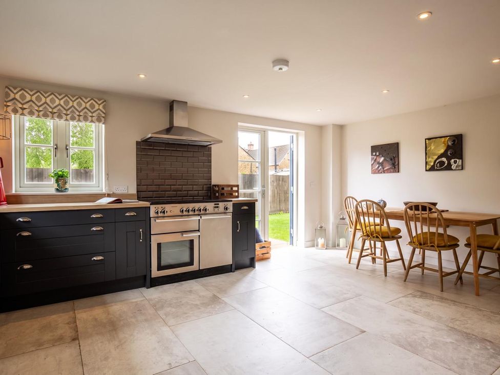 A kitchen with a stove and dining table at '' in ''