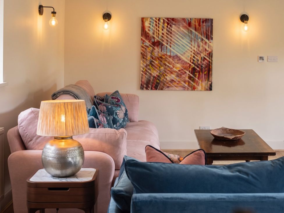 A living room with a sofa, lamp and decorative bowl at the property in the location