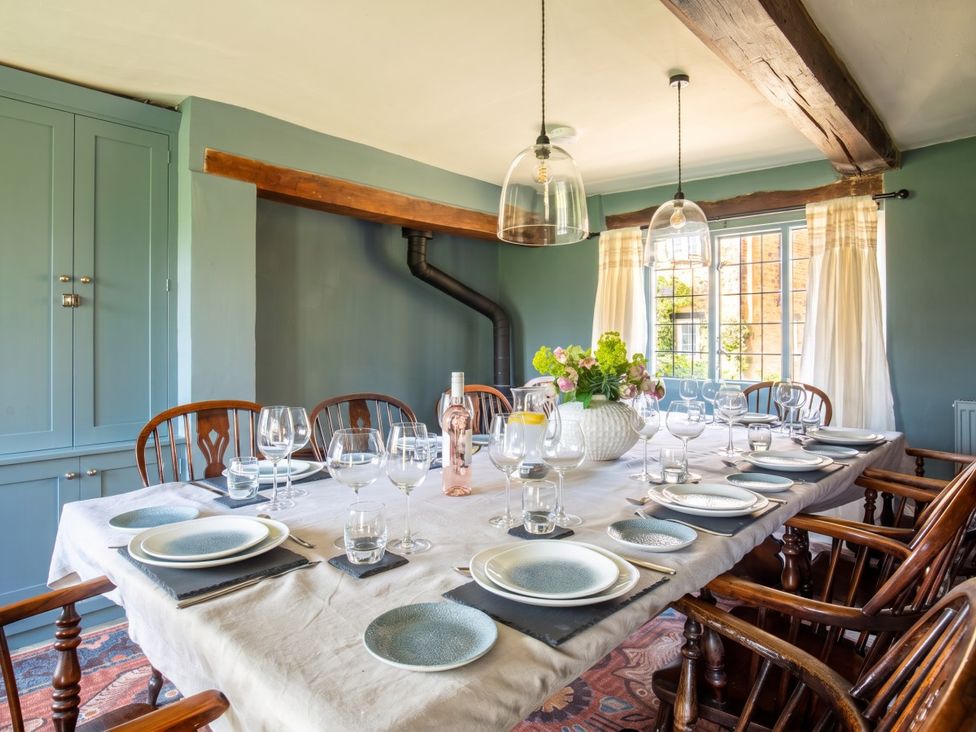 A dining table set with dishes and glasses in a dining room at The Old Barn in Manchester
