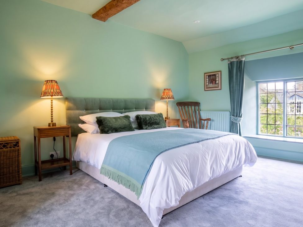 A bedroom with a bed and lamps at The Old Barn in Manchester
