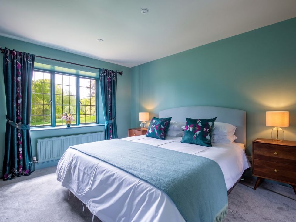 A bedroom with a bed and curtains at the property in the location