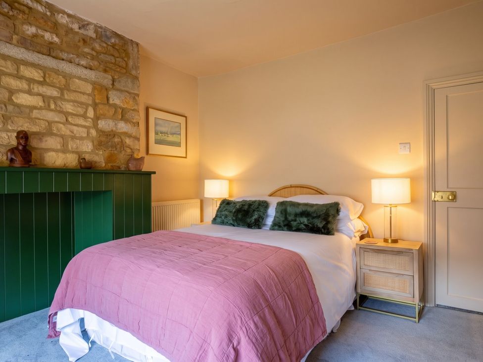 A bedroom with a bed and nightstand at The Old Barn in Manchester
