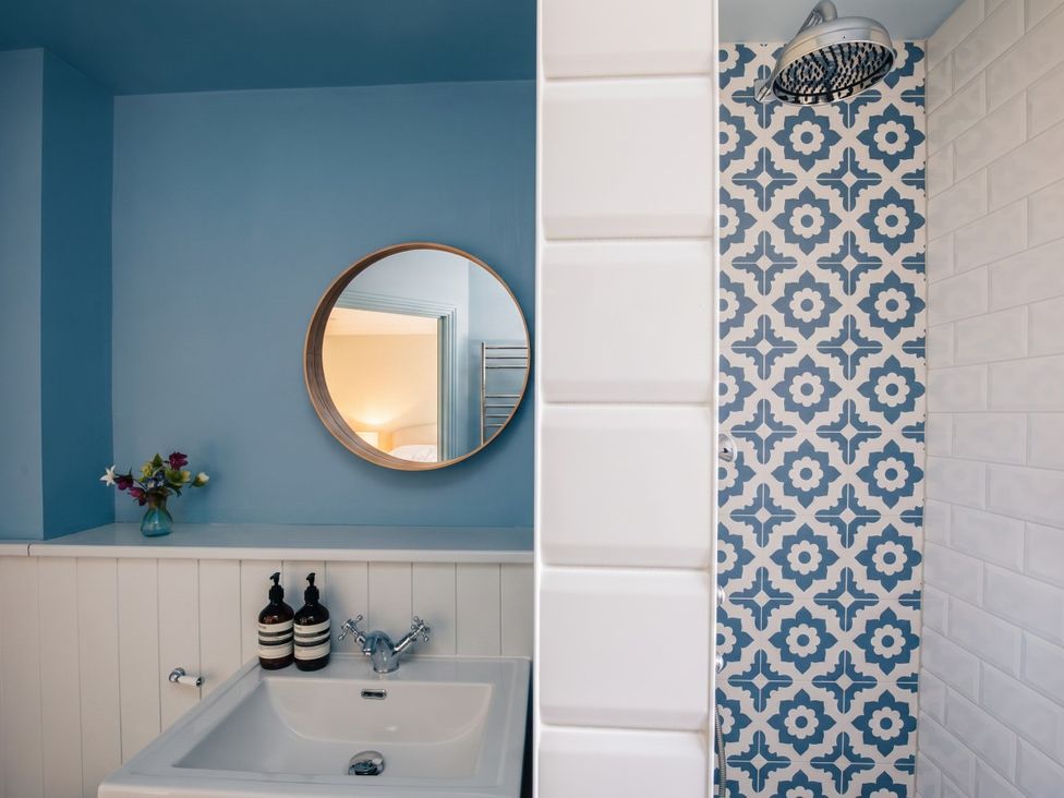 A bathroom with a sink and shower area at the property in the location
