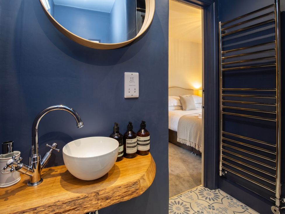 A bathroom with a sink and mirror at an unspecified location