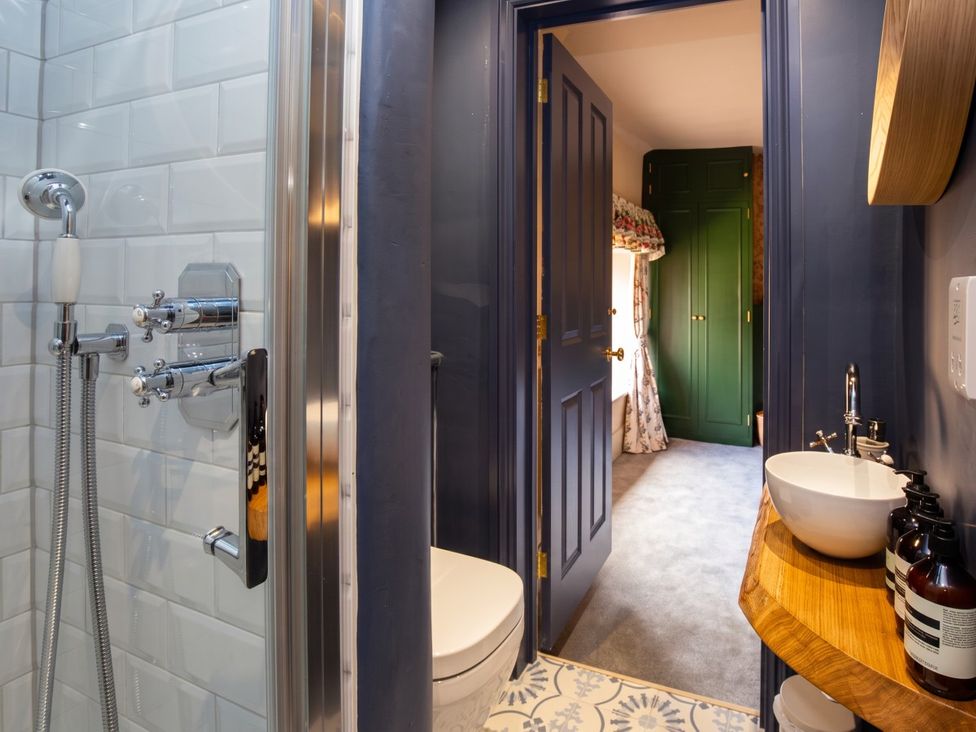 A bathroom with a shower, toilet, and sink at 