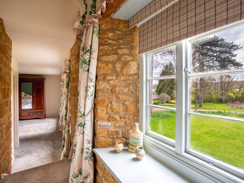 A hallway with a window and an armoire at the property in 