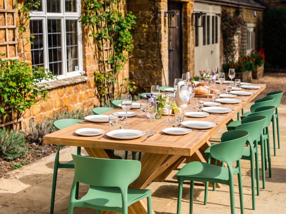 An outdoor dining area with a table set for a meal at 