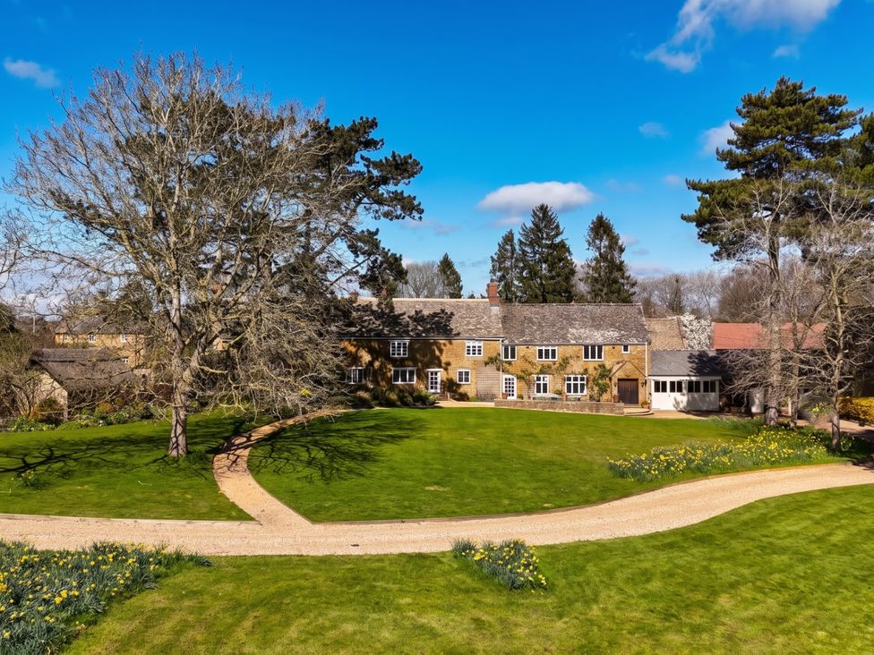 A house with a garden and trees at an unspecified location