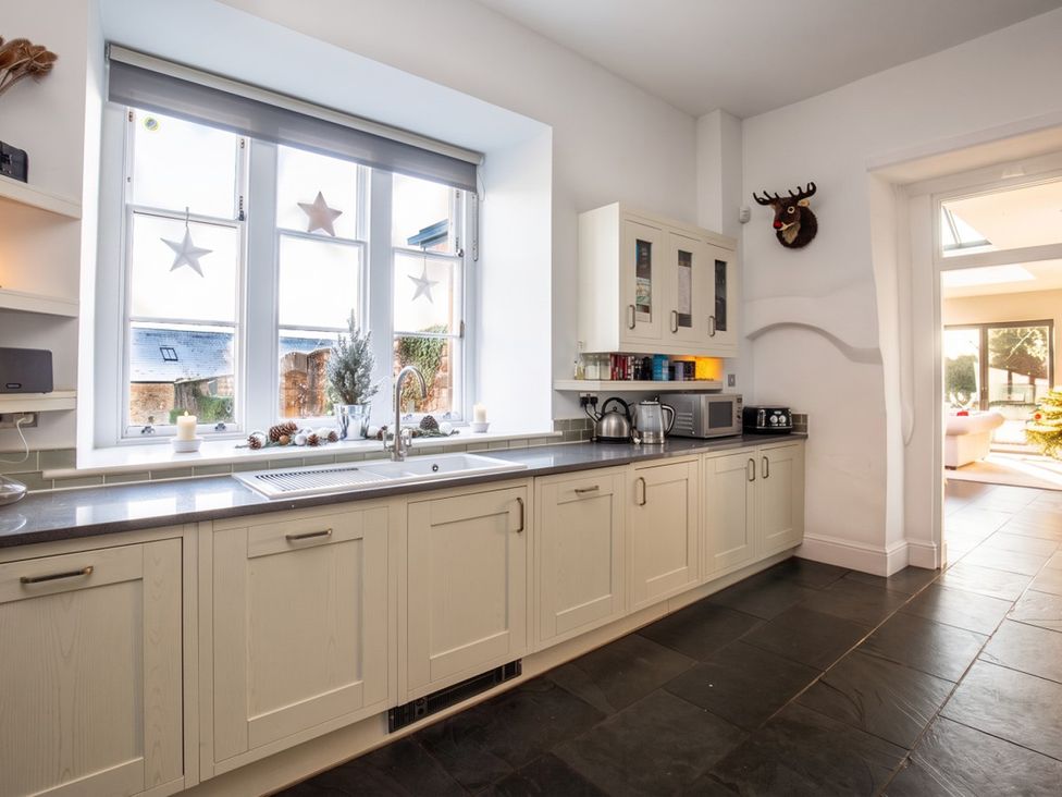 A kitchen with a sink and window at 