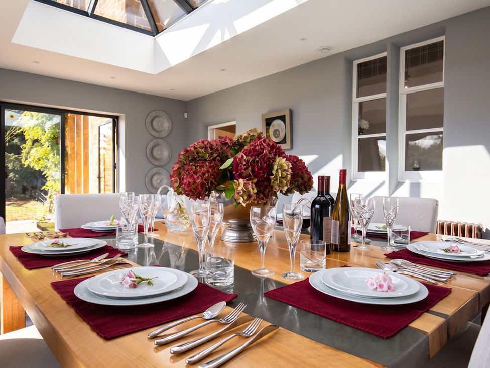 A dining room with a table set for a meal at a property