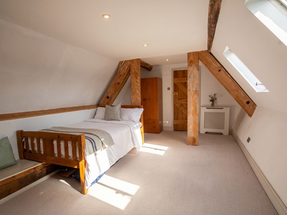 A bedroom with a bed and wooden furniture at The Old Barn in Manchester