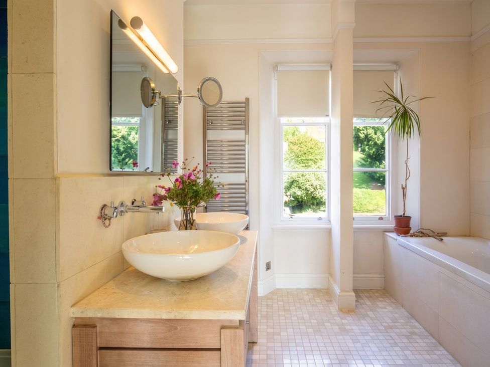 A bathroom with sinks and a bathtub at The Old Barn in Manchester