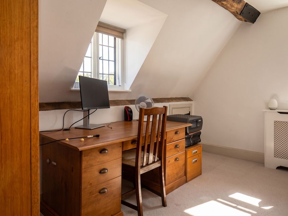 An office with a desk and computer monitor at The Old Barn in Manchester