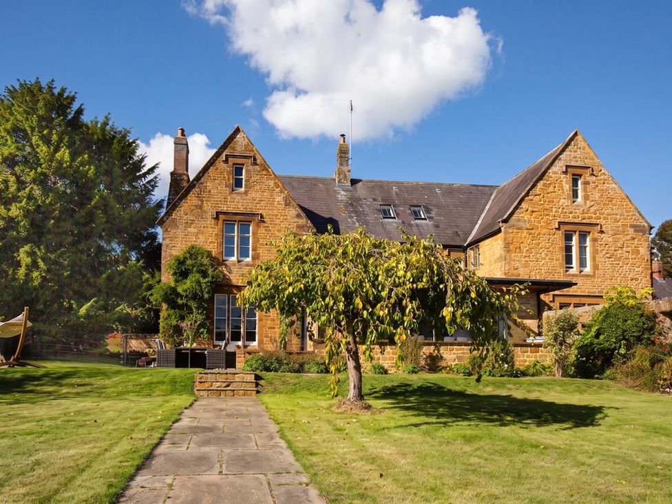 A house with a pathway and trees in the garden at The Old Barn in Manchester