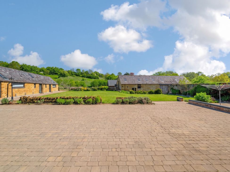 An outdoor area with buildings and a lawn at the property