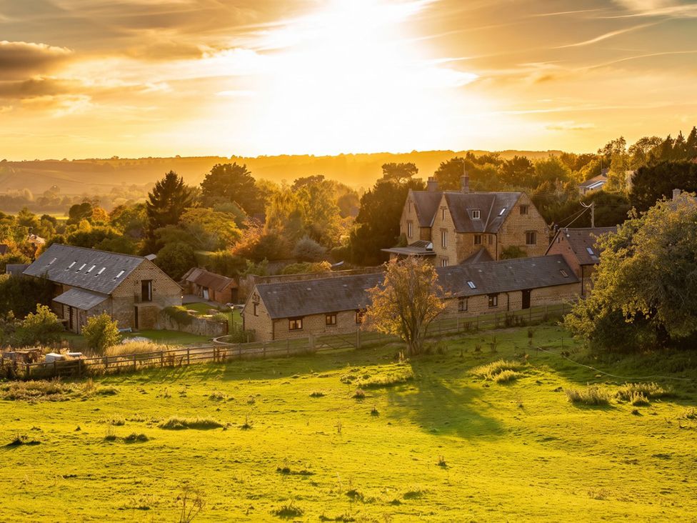 A landscape view of houses and trees during sunset