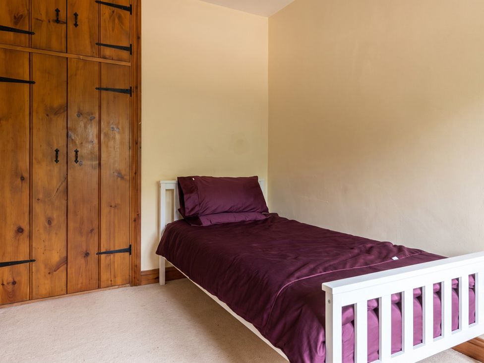 A bedroom with a bed and wardrobe at 
