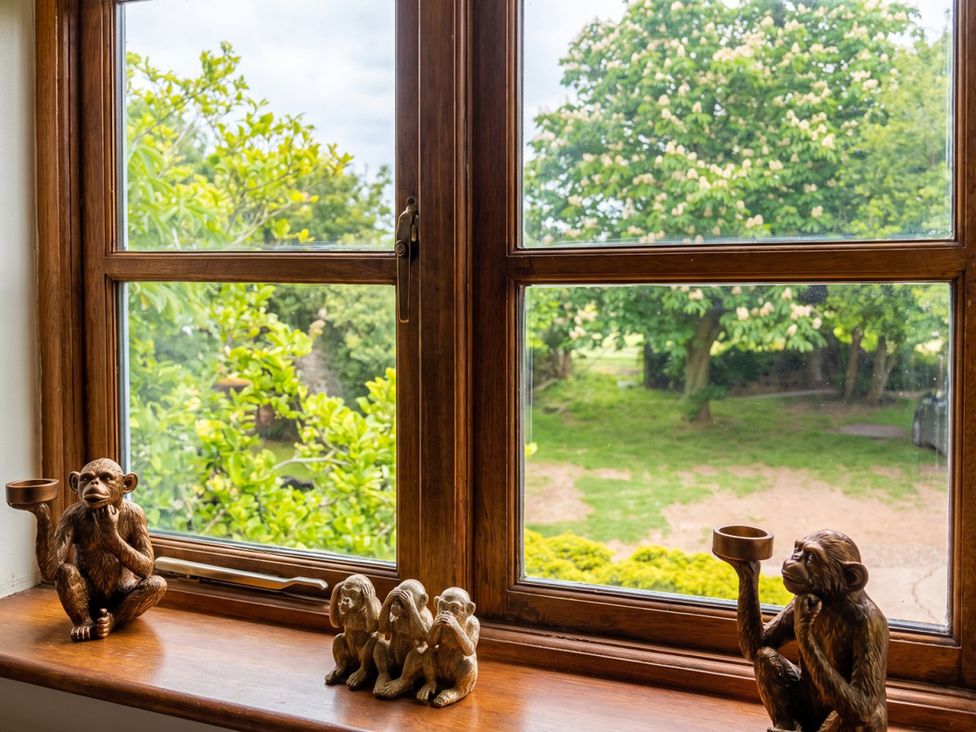 A window with monkey figurines and an outdoor view at the property in 