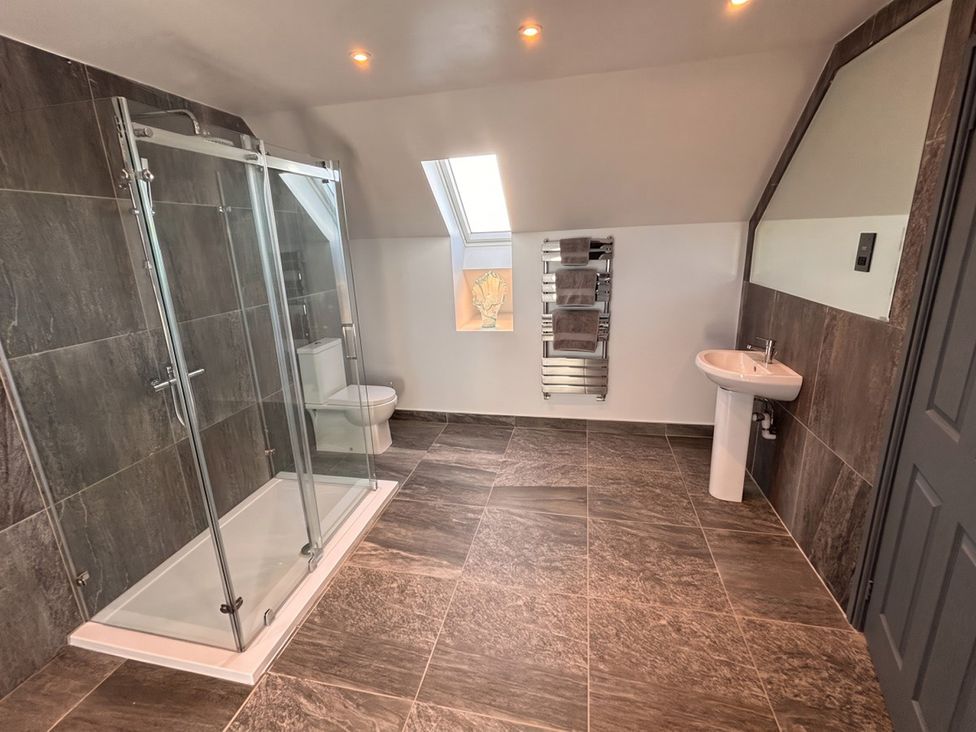 A bathroom with a shower, toilet, and sink at the property in unspecified location
