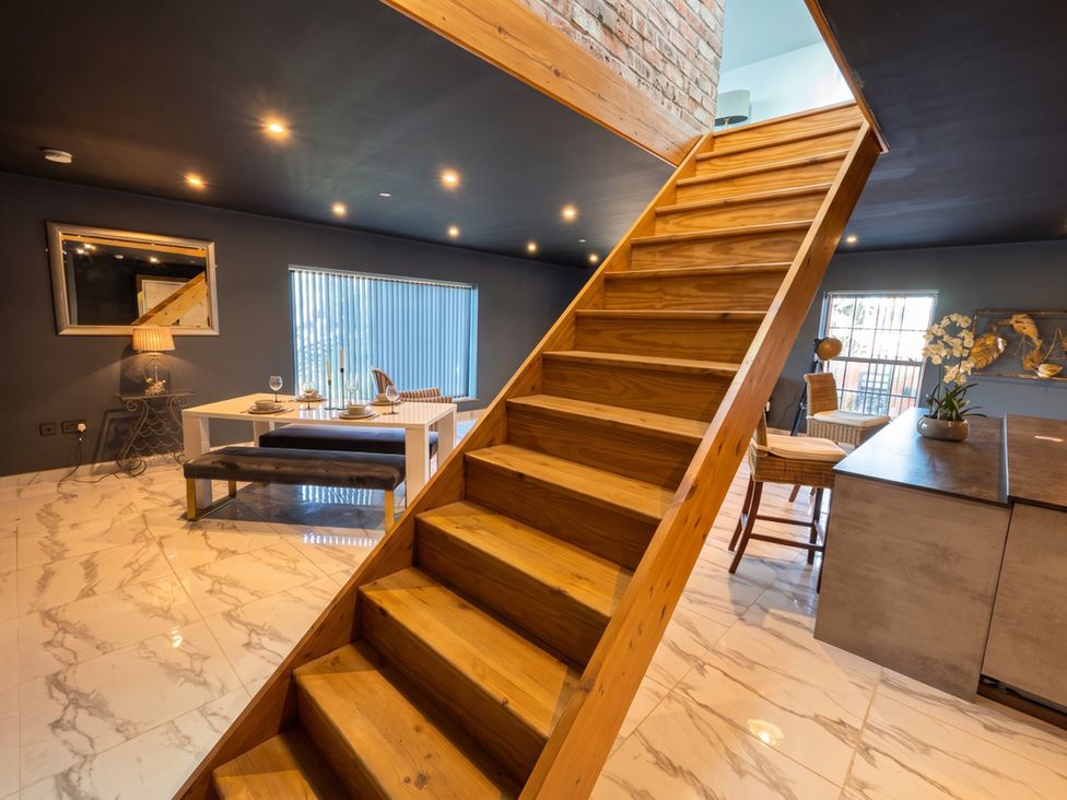 A living room with stairs and furniture at the property