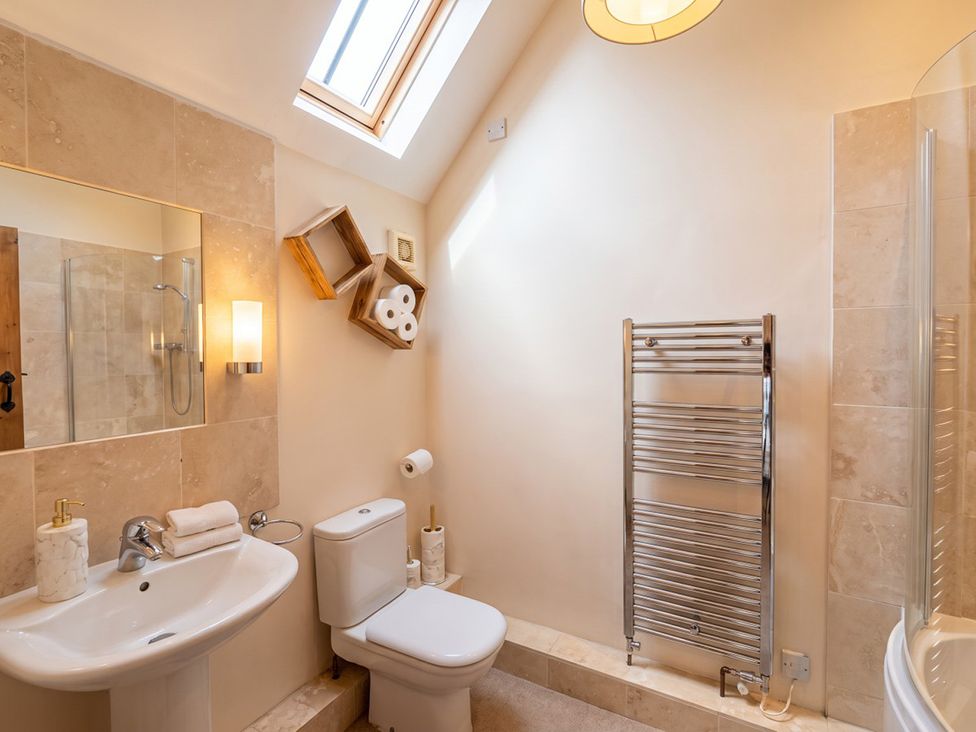 A bathroom with a sink and shower at The Old Barn in Manchester