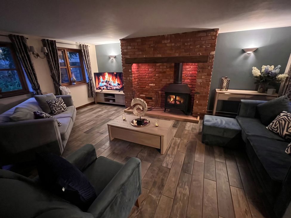 A living room with a fireplace and television at the property location