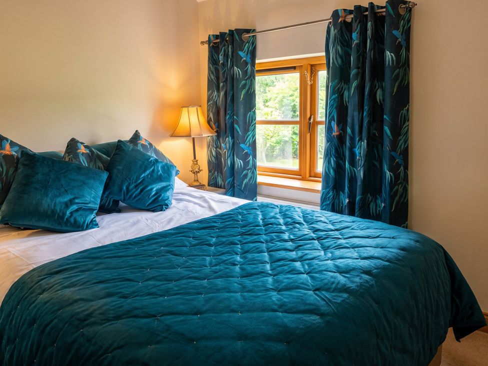 A bedroom with a bed and window at an unspecified location
