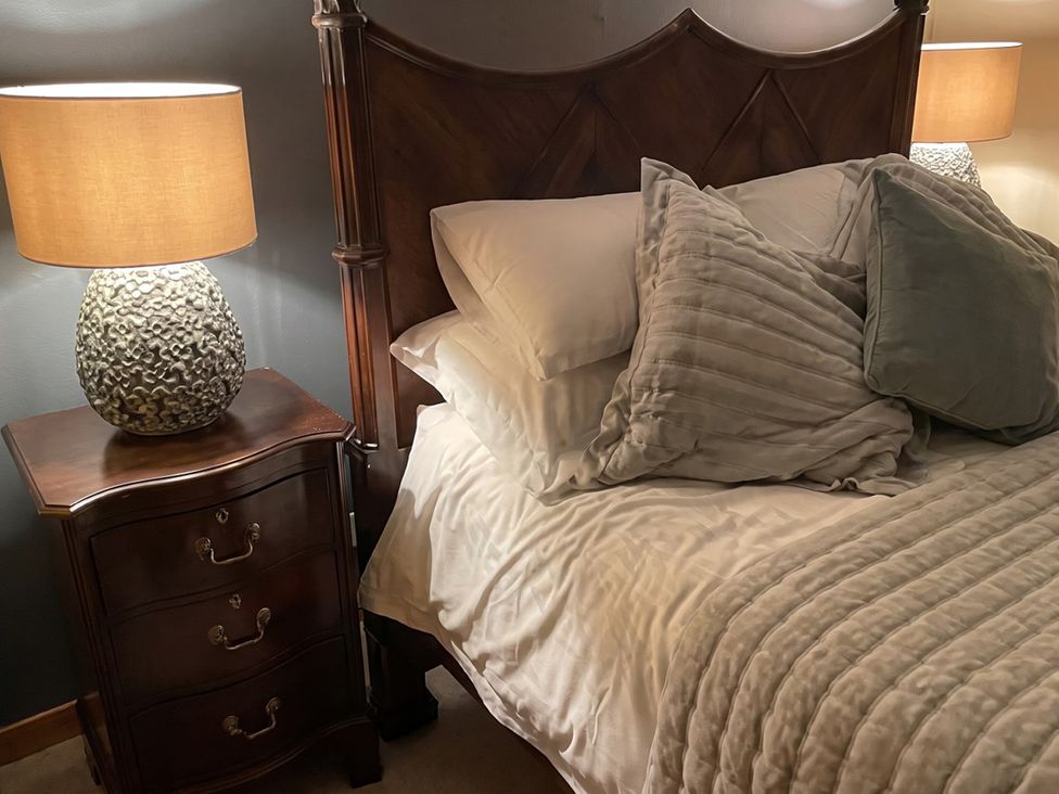 A bedroom with a bed and nightstand at the property