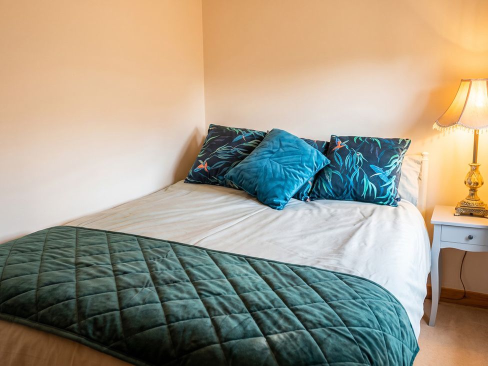 A bedroom with a bed and decorative pillows at a property