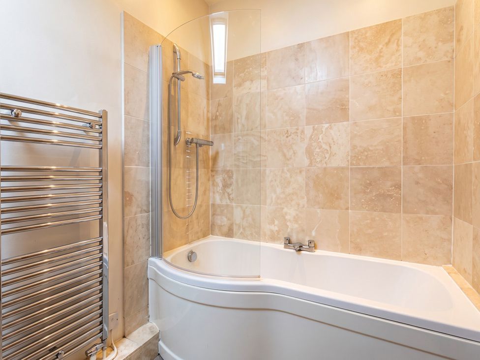 A bathroom with a bathtub and shower at 