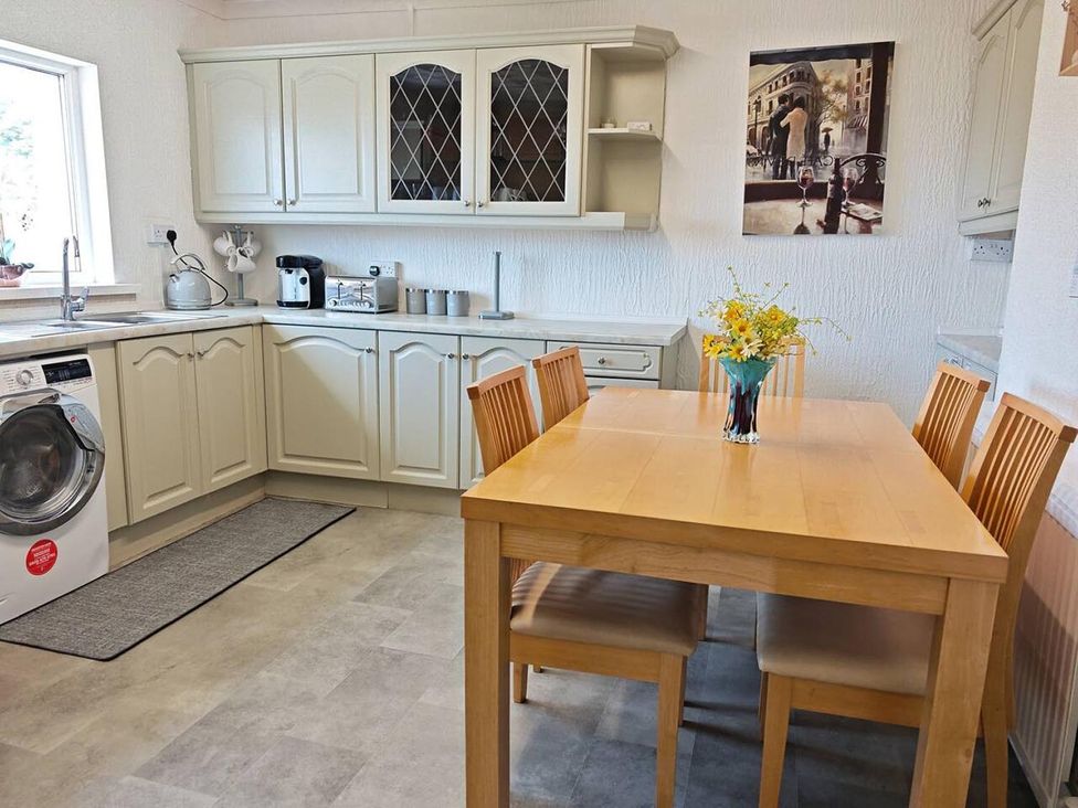 A kitchen with a dining table and chairs at The Old Barn in Manchester