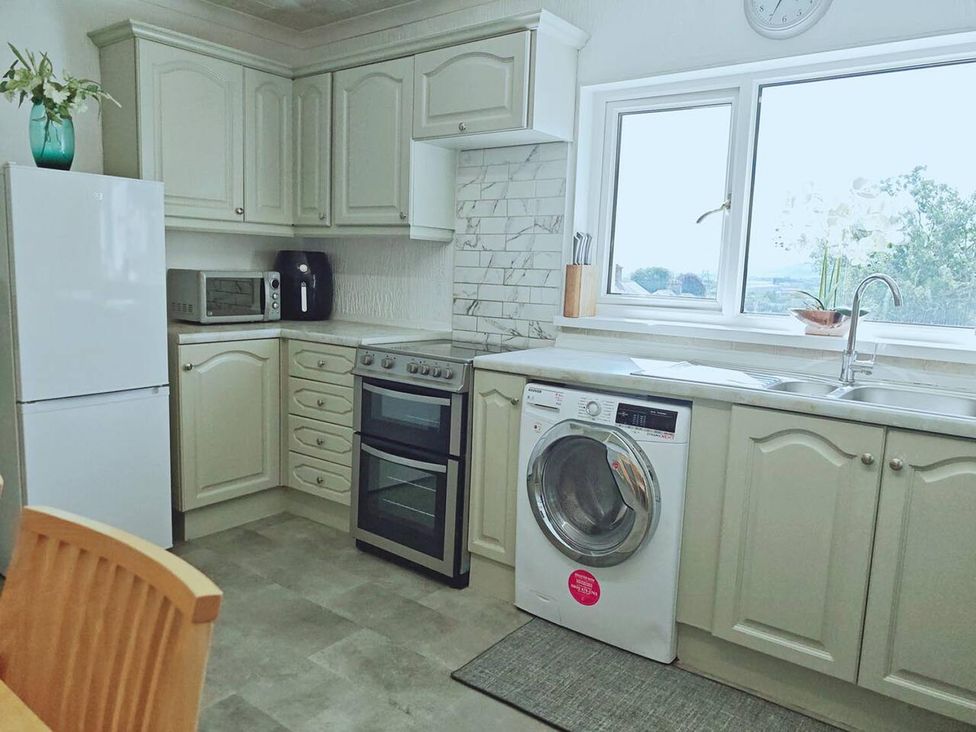 A kitchen with appliances and cabinets at the property