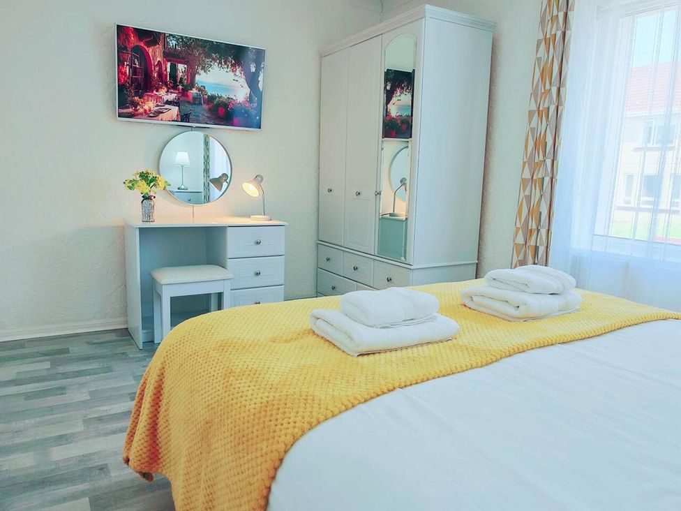 A bedroom with a bed and desk at 