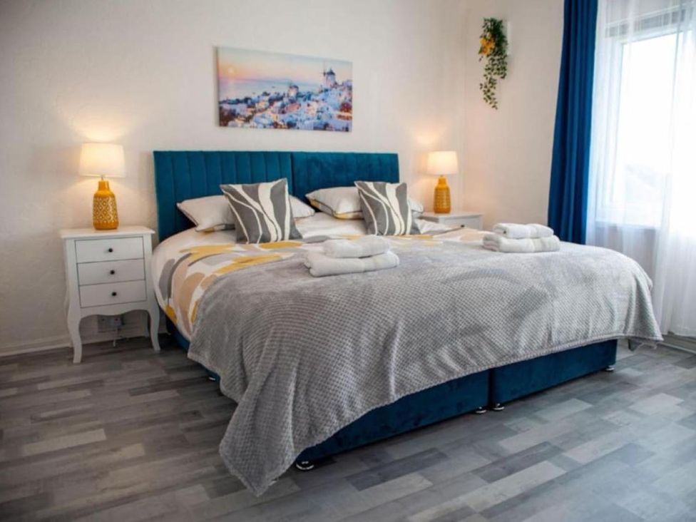 A bedroom with a bed and bedside table at The Old Barn in Manchester