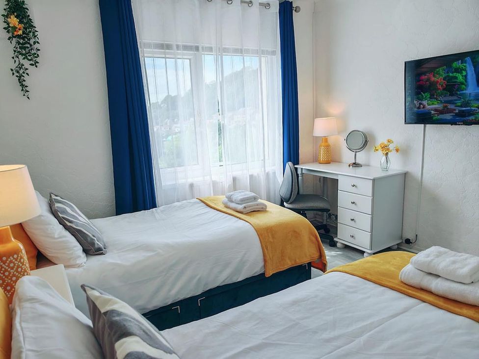 A bedroom with two beds and a desk at 