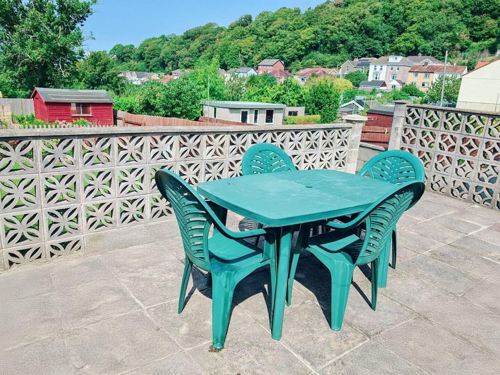 An outdoor seating area with a table and chairs at a property