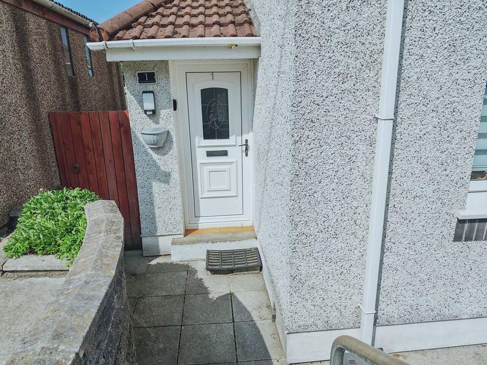 An entrance with a door and doormat at the property in 