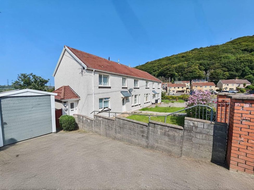 A house with a garage and garden area at the property
