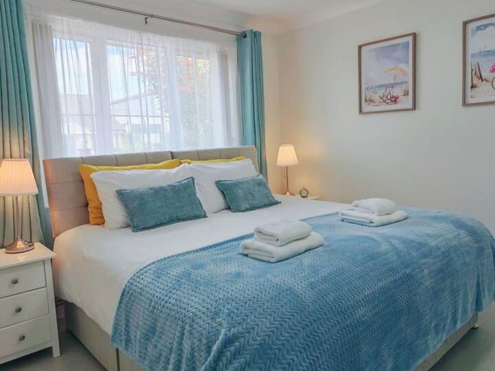 A bedroom with a bed and nightstand at The Old Barn in Manchester