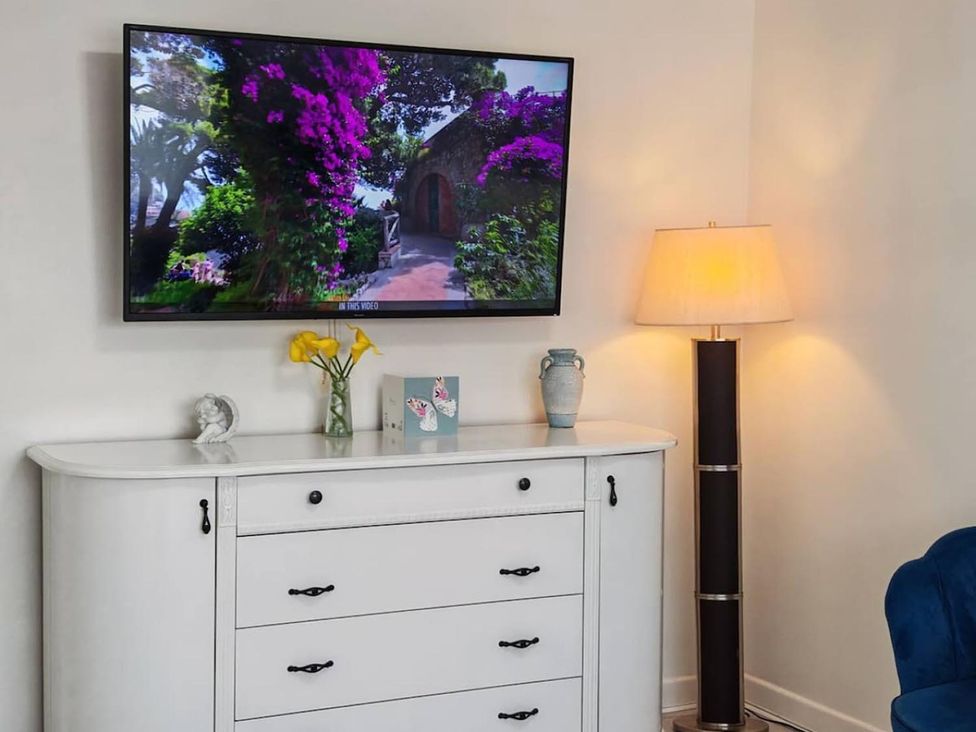 A living room with a television mounted on the wall at 