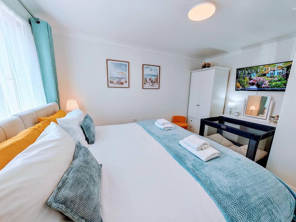 A bedroom with a bed and wardrobe at The Old Barn in Manchester